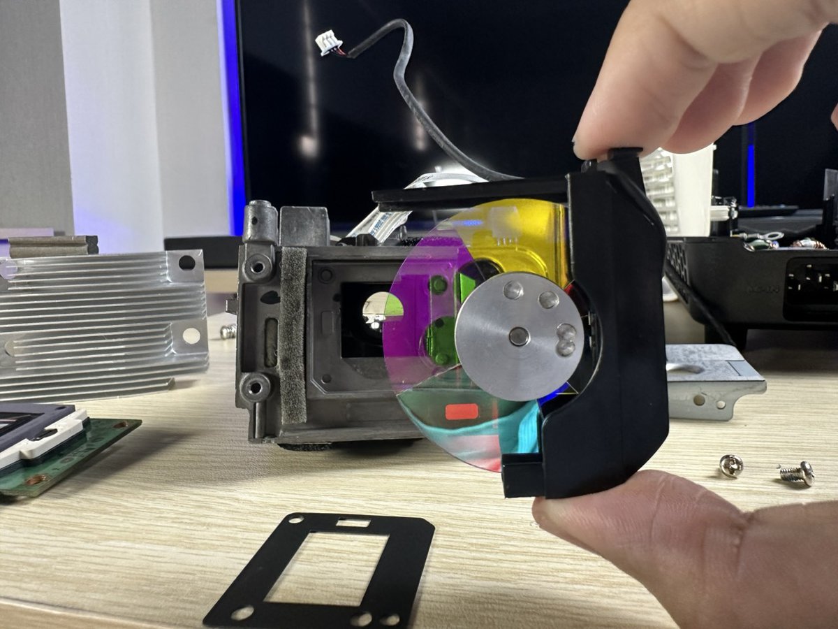 Disassembled projector showing the color wheel and optical engine