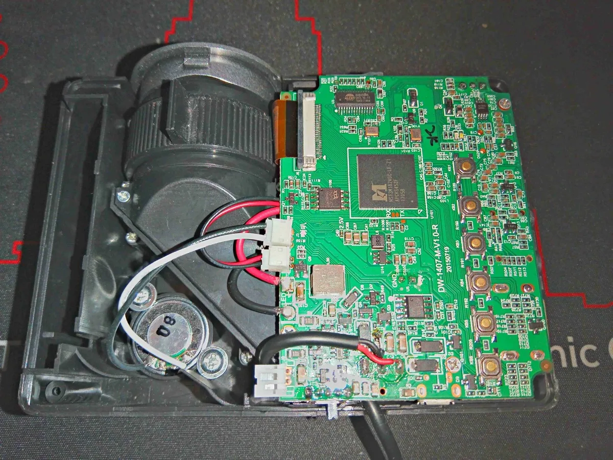 Inside an LED projector showing the mainboard, optical assembly, and lens barrel