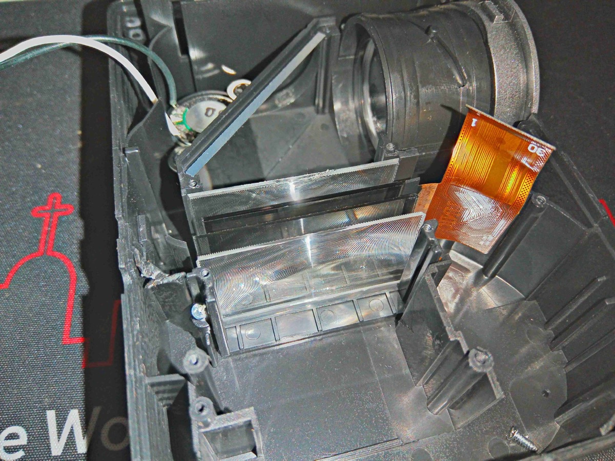 Close-up of LCD panel and lens assembly inside a projector