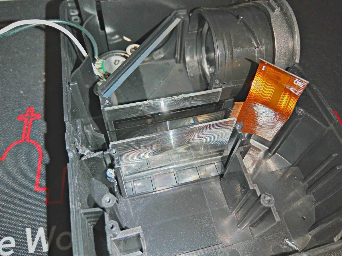 Close-up of LCD panel and lens assembly inside a projector