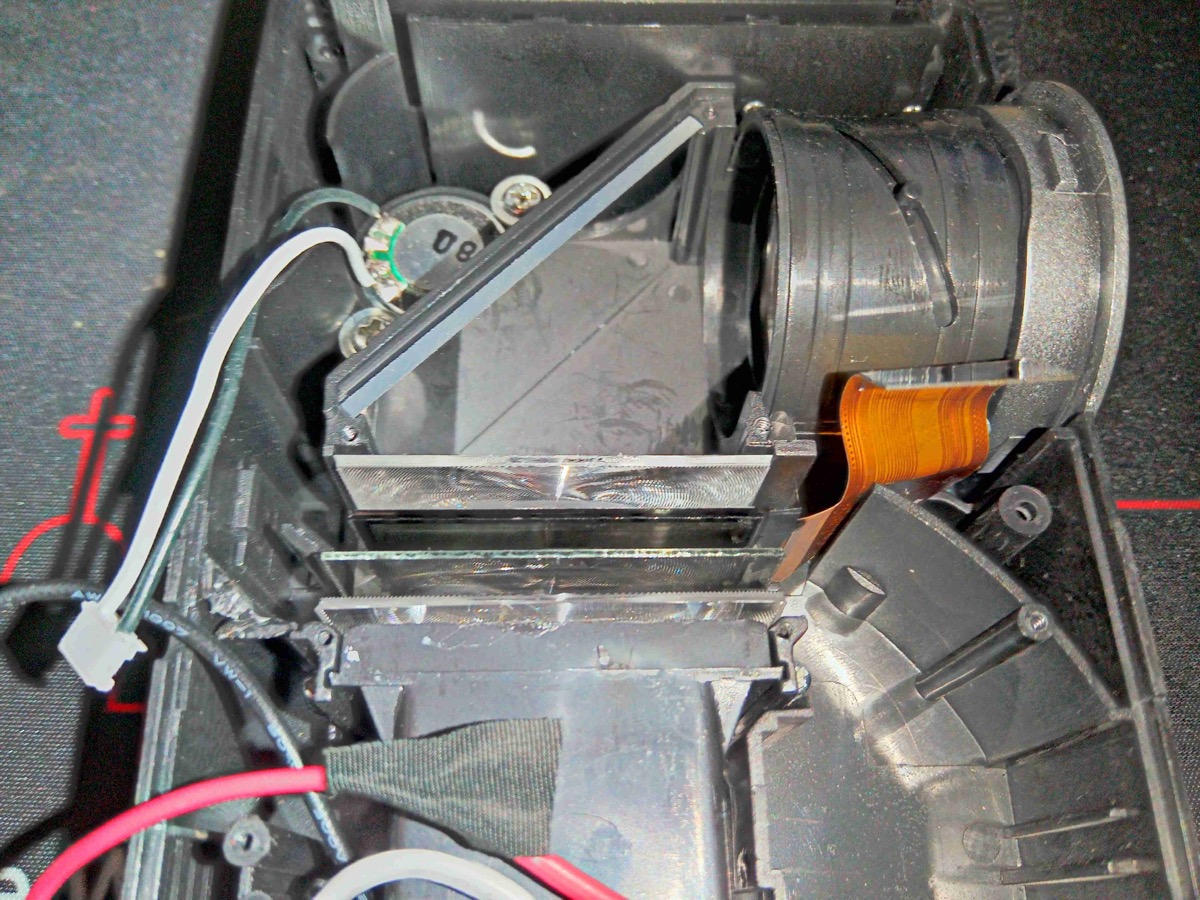 Projector optical assembly showing mirrors, LCD panel, and projection lens