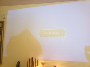 Projector screen showing a large yellow-brown blob from polarizer overheating